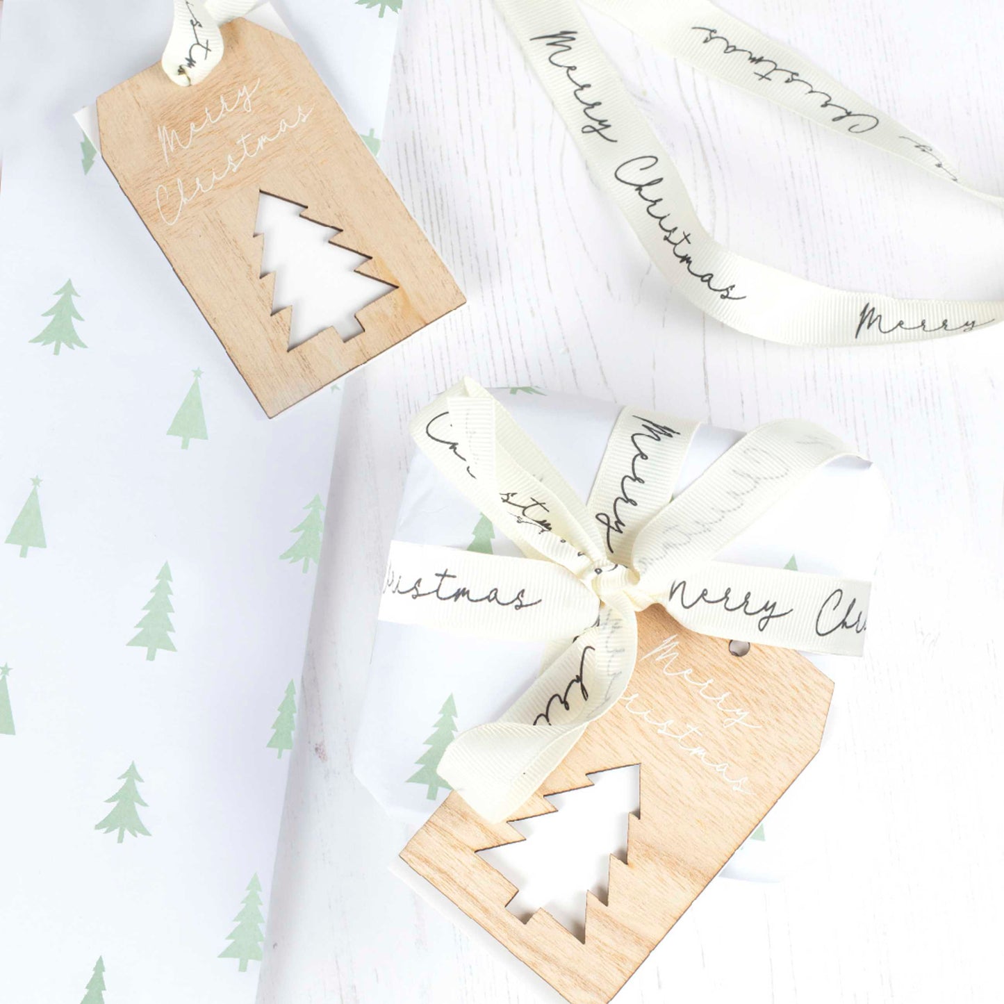 Christmas wrapping paper with ribbon and wooden tag